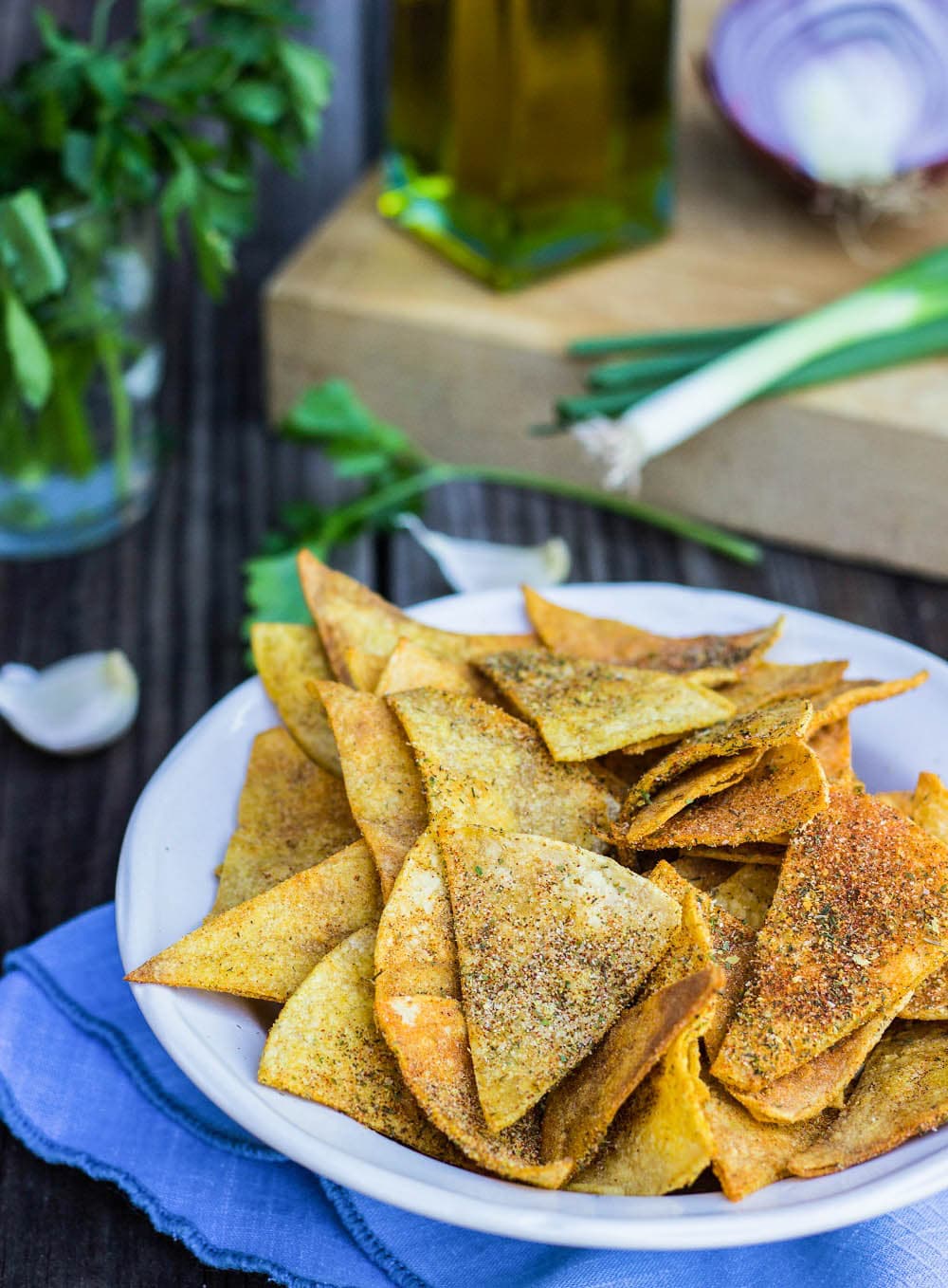 Bowl of Homemade Cool Ranch Doritos with herbs behind