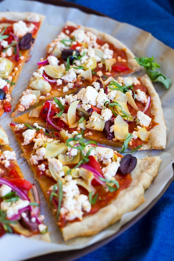 This Vegan Greek Pizza is so full of delicious and fresh flavor that you won't even miss the dairy! Vegan tofu feta adds tons of creaminess and tang! Perfect for your next pizza night!