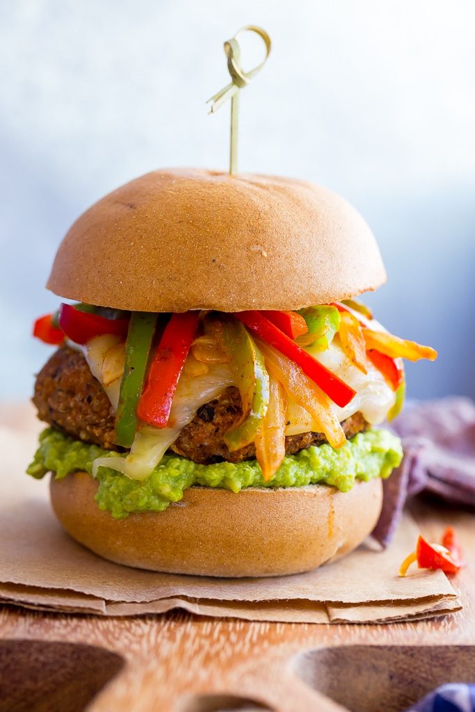 Jazz up your veggie burgers by making these Black Bean Fajita Veggie Burgers! Topped with fajita peppers and onions, pepperjack cheese and guacamole! {gluten free}