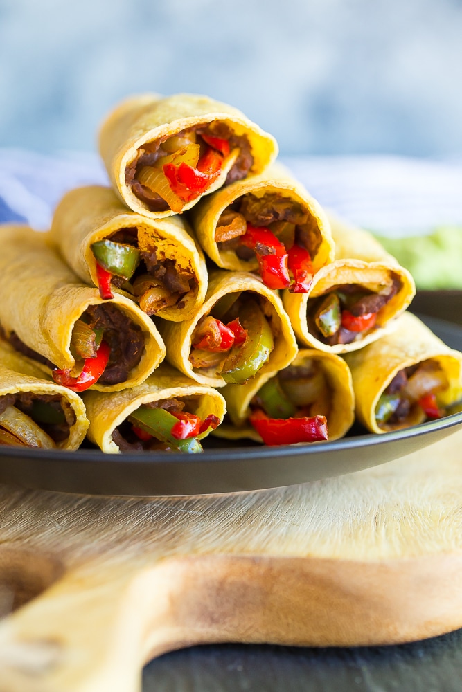 These Baked Fajita Taquitos combine two amazing Mexican dishes into one delicious dinner that is gluten free and vegan! They only require a few ingredients and are so easy to make!