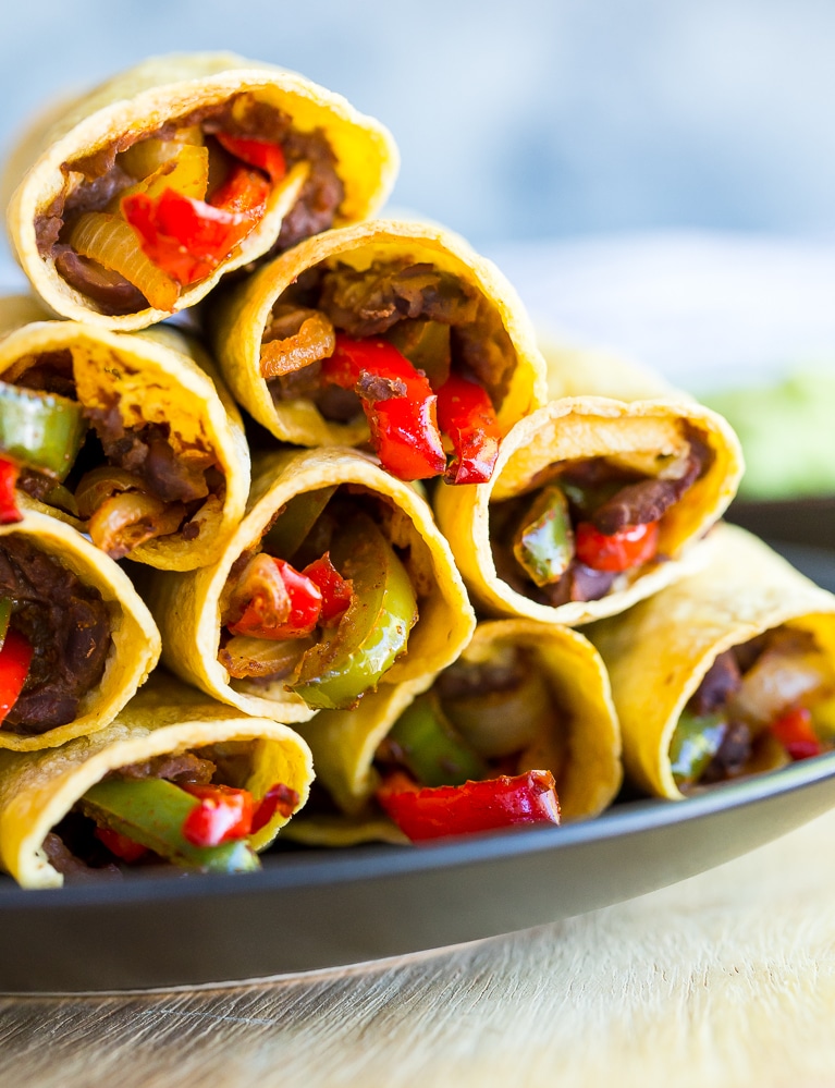 These Baked Fajita Taquitos combine two amazing Mexican dishes into one delicious dinner that is gluten free and vegan! They only require a few ingredients and are so easy to make!