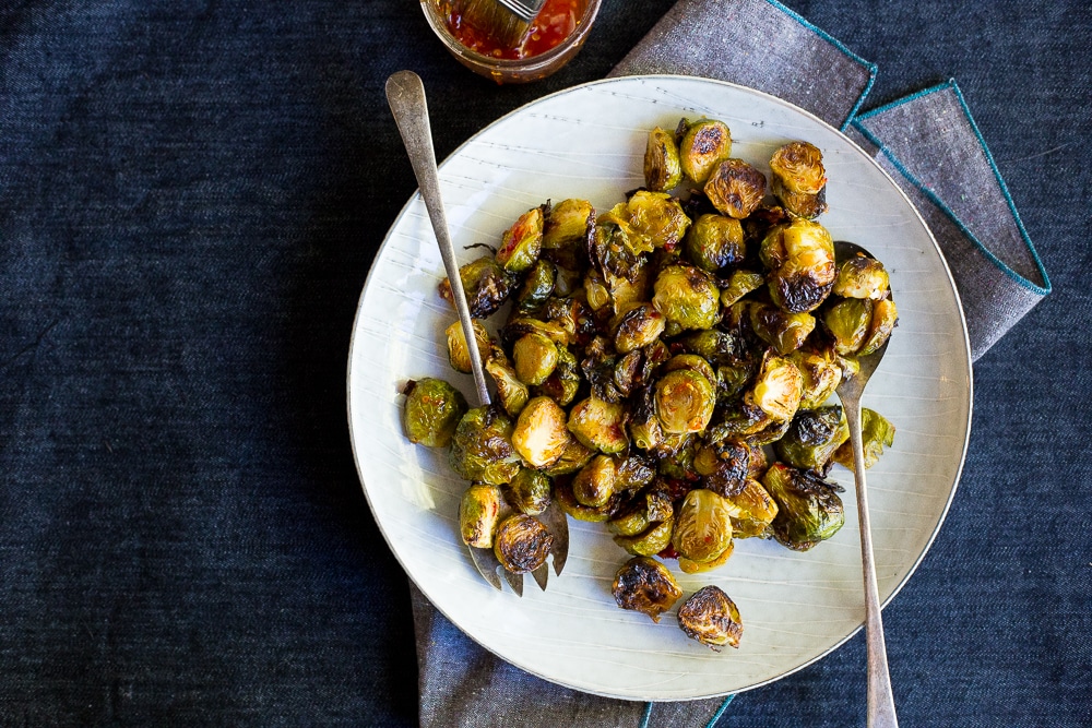 These Sweet Chili Roasted Brussels Sprouts are the perfect way to mix up your traditional brussels sprouts! They're the perfect side dish! Vegan and gluten free