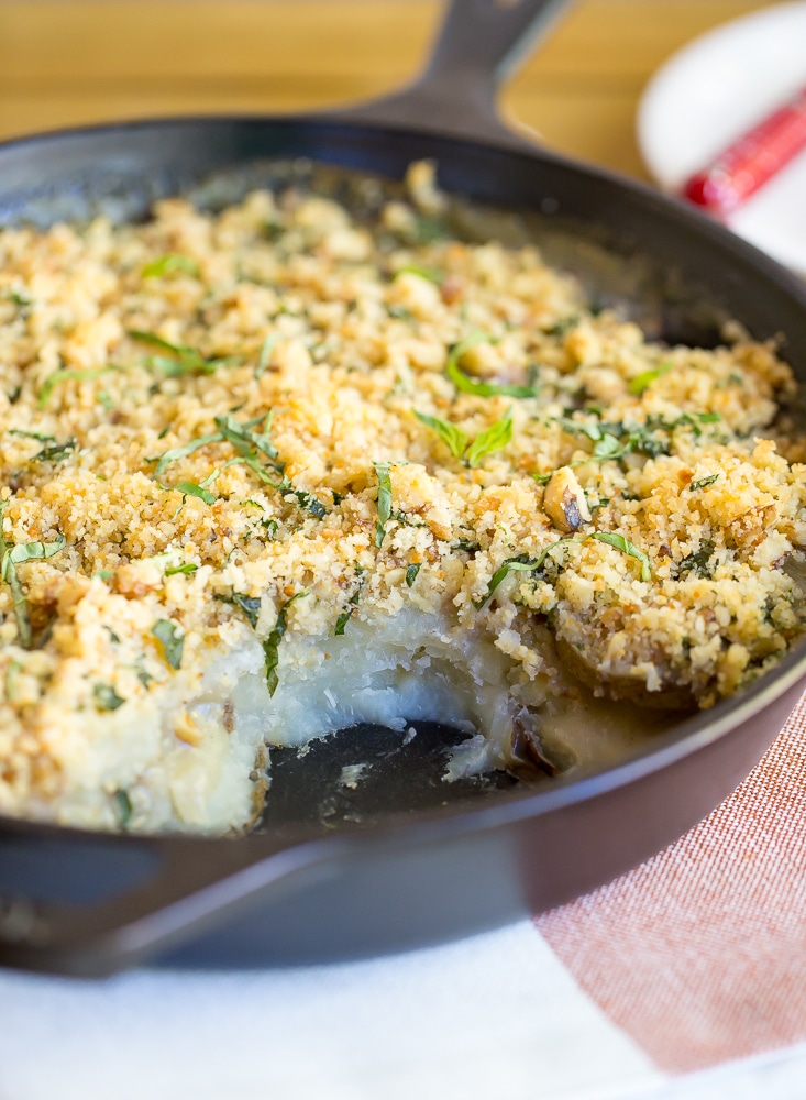 Vegan Scalloped Potatoes with Crispy Pesto Breadcrumbs! So creamy and flavorful with a delicious crispy topping. The perfect side dish for your holiday meal! Gluten free too!