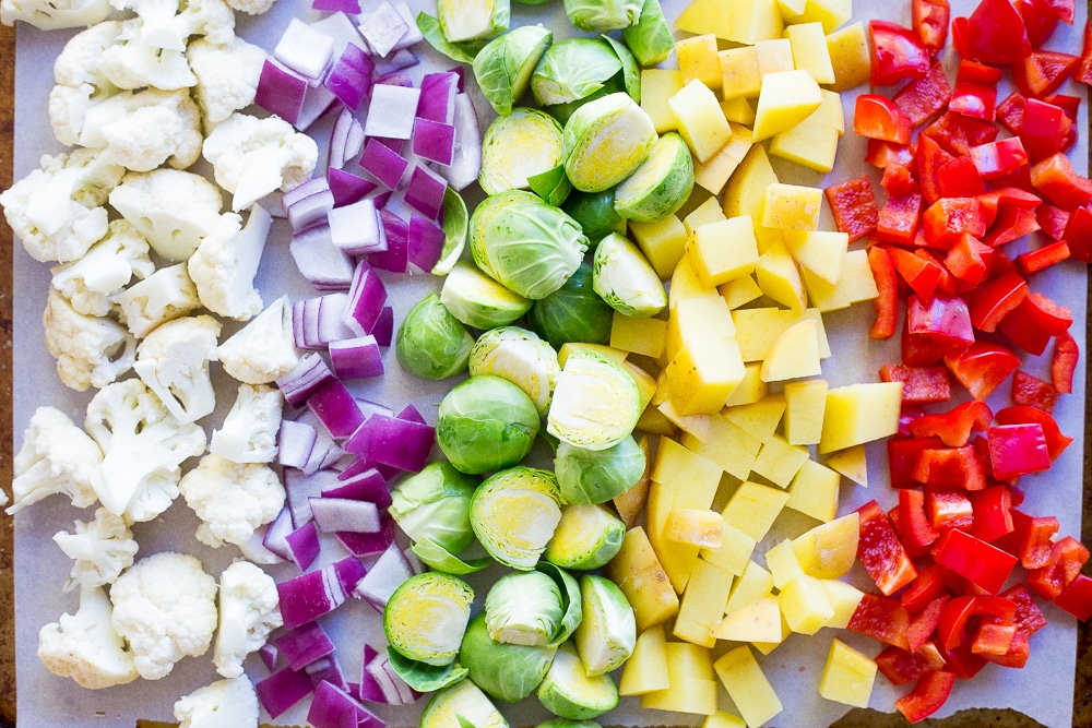 These Roasted Veggie Buddha Bowls are so healthy and delicious! Just put everything in one bowl for a perfect comfort food dinner! All topped off with some refreshing pesto. Gluten free and vegan!