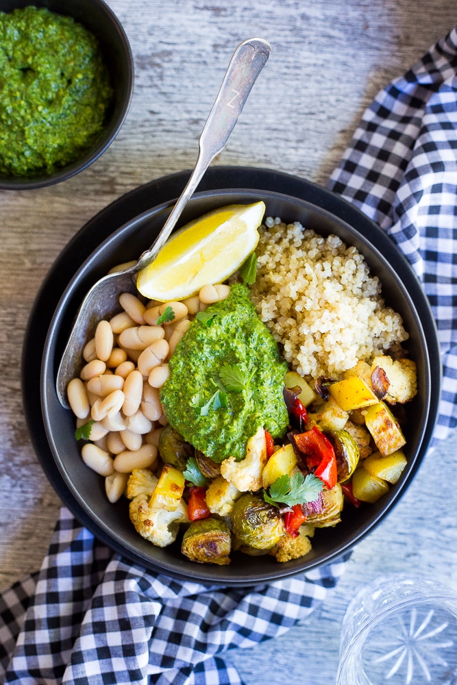 These Roasted Veggie Buddha Bowls are so healthy and delicious! Just put everything in one bowl for a perfect comfort food dinner! All topped off with some refreshing pesto. Gluten free and vegan!