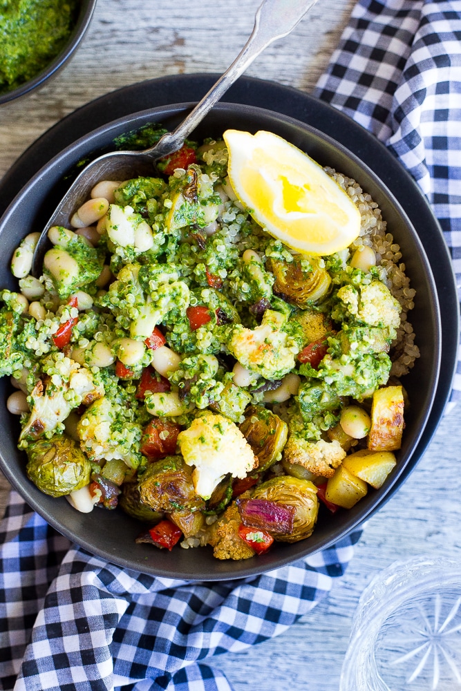 These Roasted Veggie Buddha Bowls are so healthy and delicious! Just put everything in one bowl for a perfect comfort food dinner! All topped off with some refreshing pesto. Gluten free and vegan!