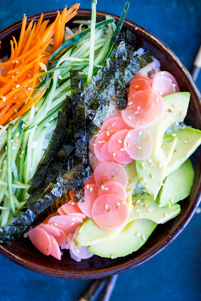 These Veggie Sushi Bowls with Quick Pickled Radishes come together really quickly for a delicious and healthy meal! Eat them for dinner or make them as a lunch meal prep idea! Vegan and gluten free!