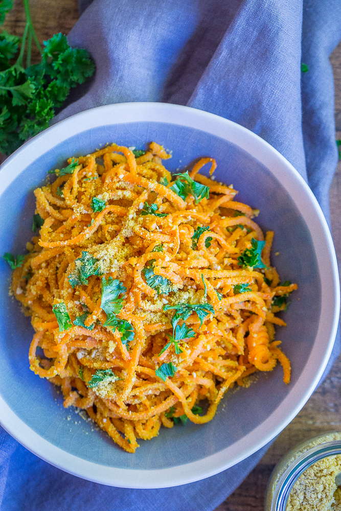 These Garlic Parmesan Sweet Potato Noodles are a fun and delicious side dish or can be eaten for dinner and lunch when you add a little protein! Easy to make, gluten free and vegan!