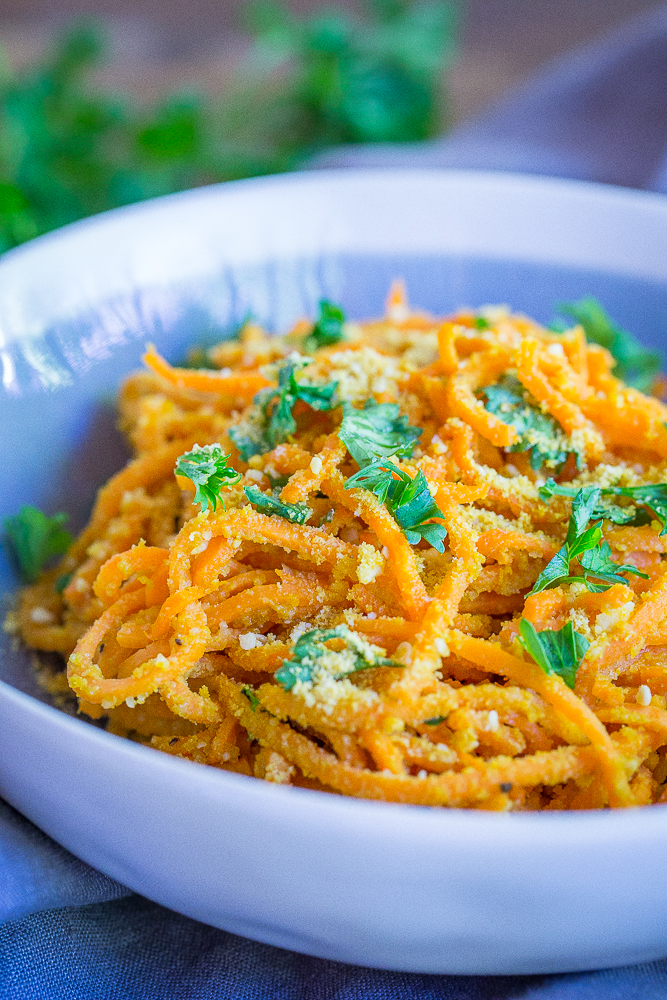 These Garlic Parmesan Sweet Potato Noodles are a fun and delicious side dish or can be eaten for dinner and lunch when you add a little protein! Easy to make, gluten free and vegan!