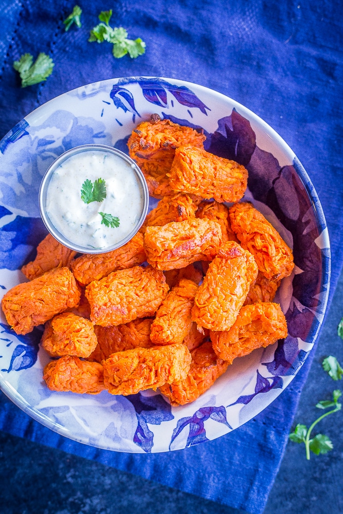 Sweet potato tots in a bowl with curry cilantro dip