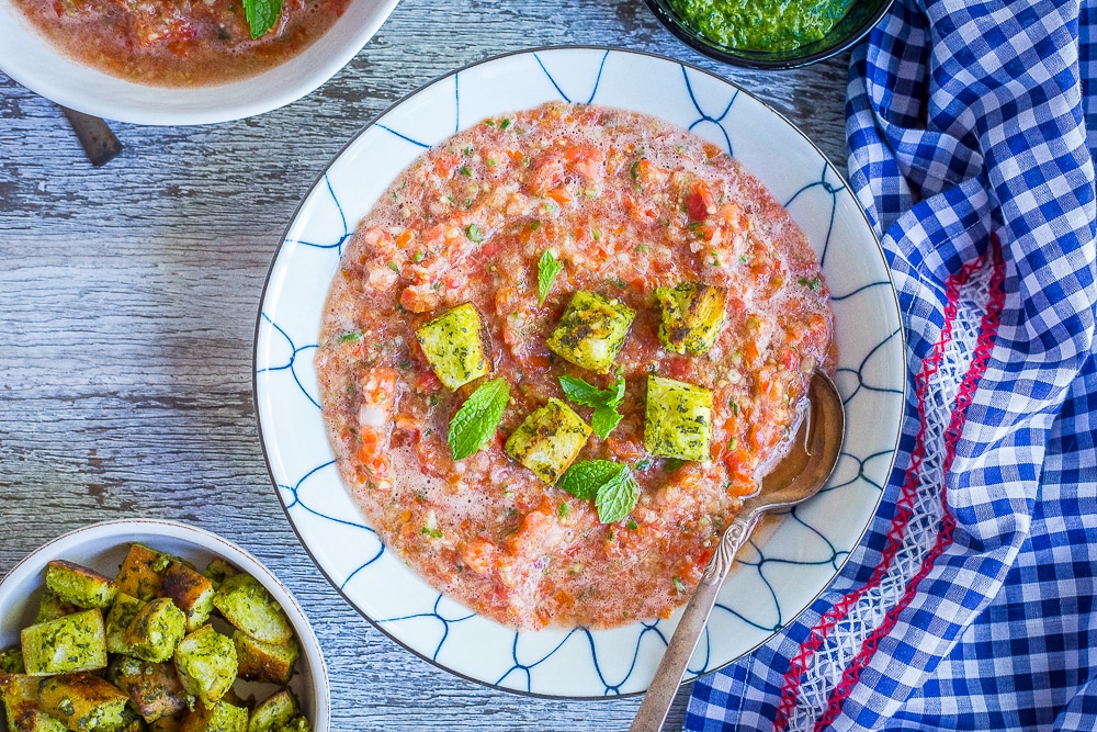 Two bowls of Chunky Cherry Tomato Gazpacho with mint croutons.