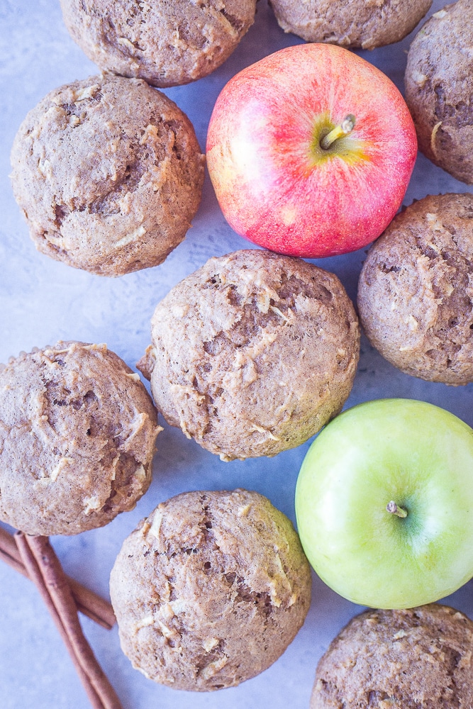 Best Healthy Apple Cinnamon Muffins on a table with apples and cinnamon sticks