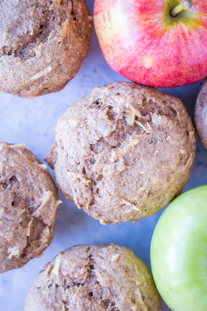 Close up of Best Healthy Apple Cinnamon Muffins on a table with apples