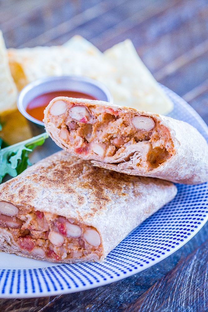 Close up of a Make Ahead Bean Burrito sliced in half