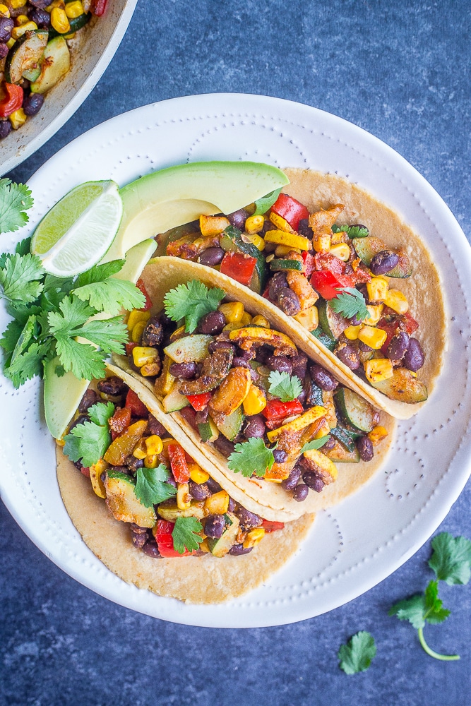Three Vegan Black Bean Tacos with Summer Vegetables in a white bowl