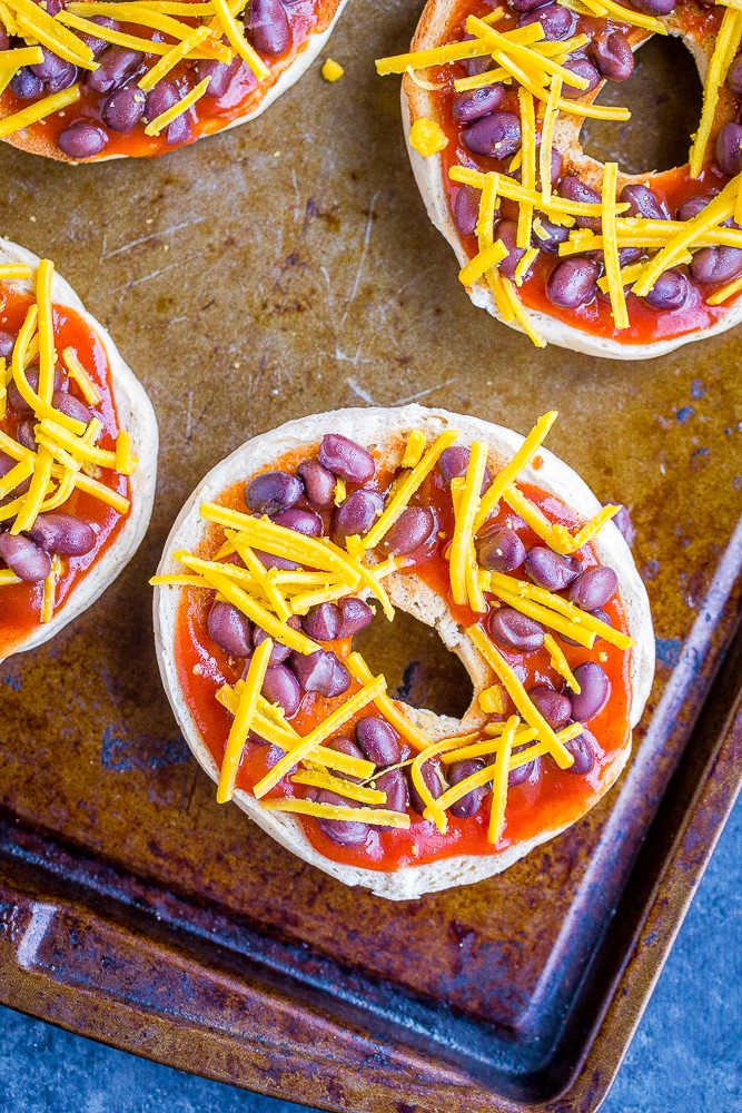 Taco Pizza Bagels on a sheet pan ready to go in the oven