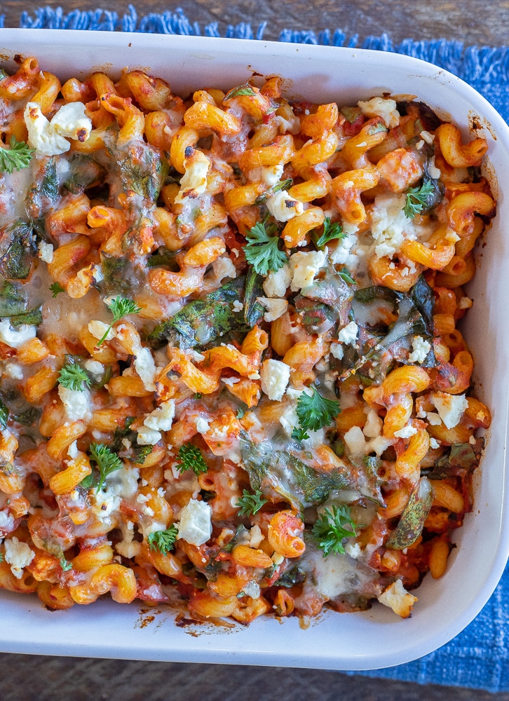 Spinach Feta Baked Pasta in a dish on a blue napkin