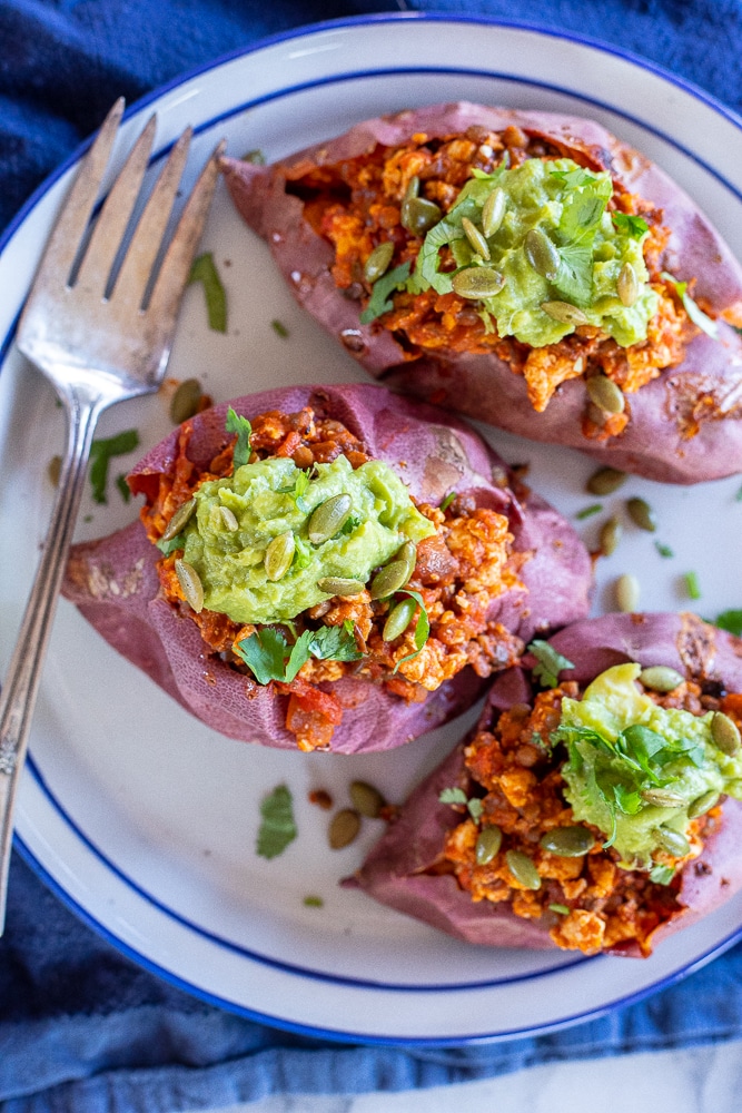 A plate with three sloppy Joe stuffed sweet potatoes