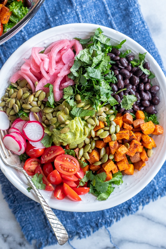 big bowl of roasted sweet potato and kale salad with black beans