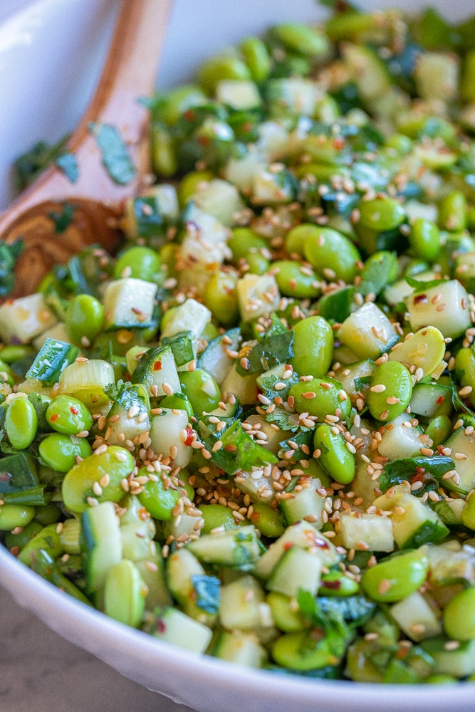 close up of cucumber edamame salad with toasted sesame seeds on it