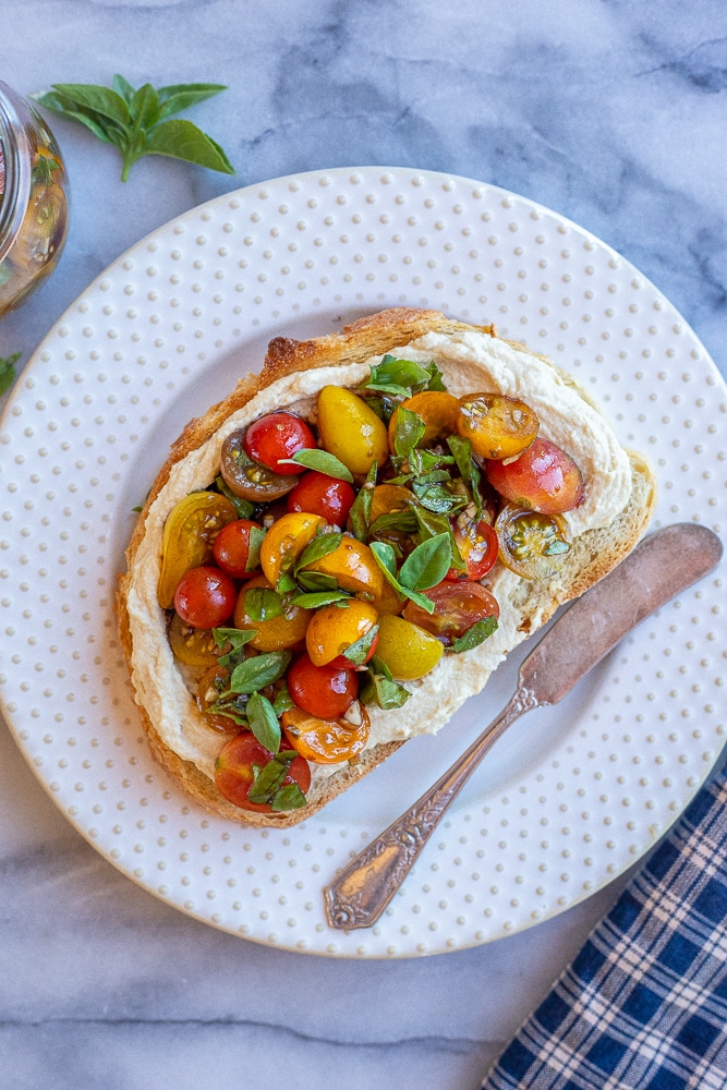 hummus toast with bruschetta on a plate