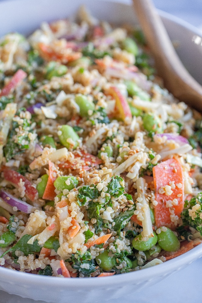 close up of quinoa and kale salad with edamame and carrots