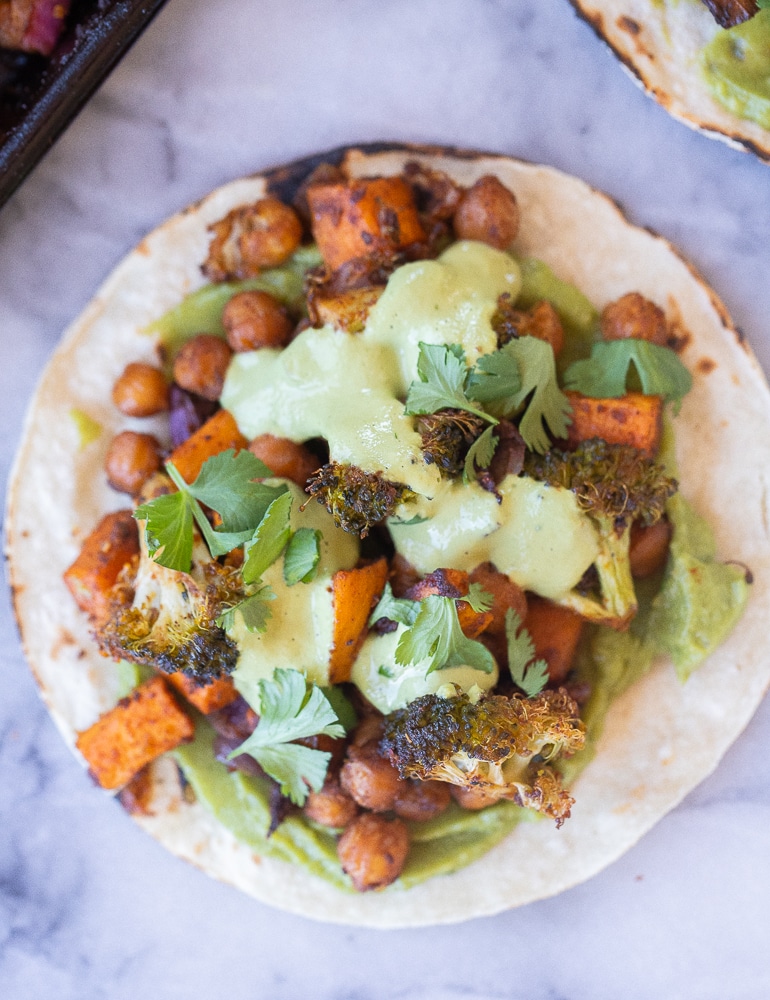 close up of a roasted sweet potato taco with tahini sauce