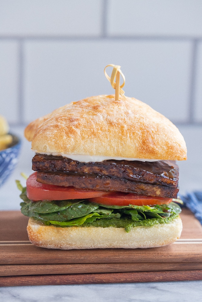 balsamic glazed tofu sandwich on a cutting board
