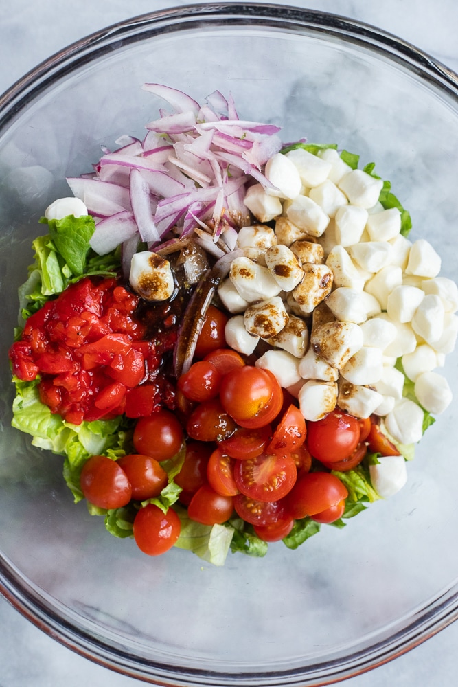 caprese salad ingredients in a bowl with balsamic