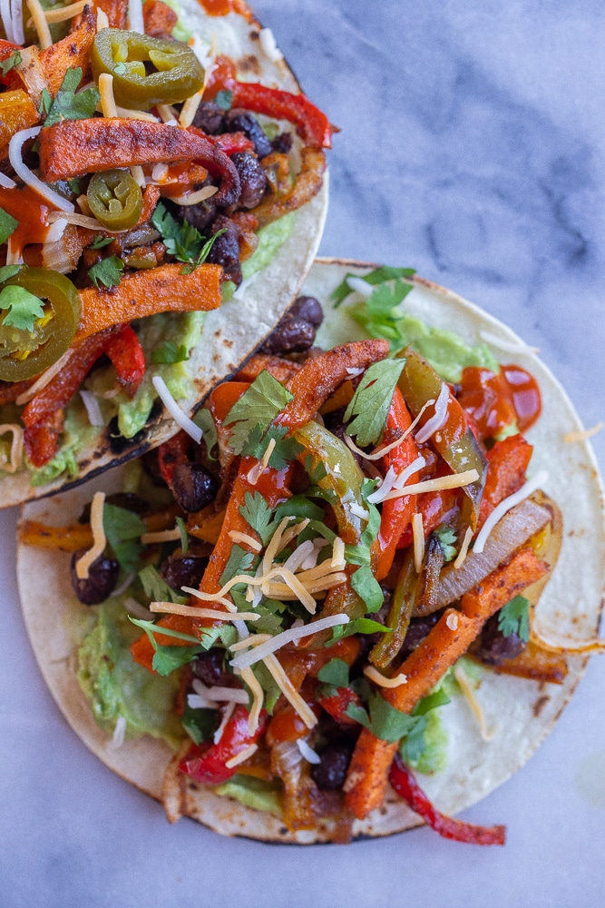 close up of a sheet pan sweet potato and black bean fajita on a cutting board