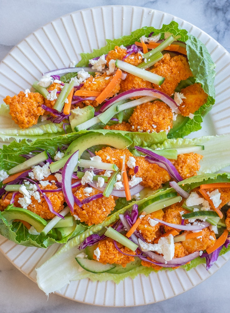 A plate of three buffalo tofu lettuce wraps