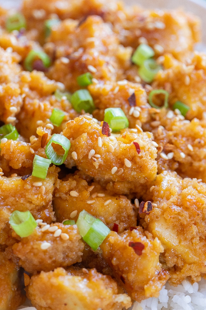 close up of a piece of crispy orange tofu