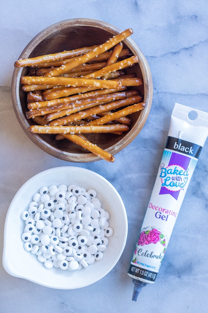 pretzel sticks, candy eyes and decorating gel that is used to decorate these healthy Frankenstein Halloween Bars