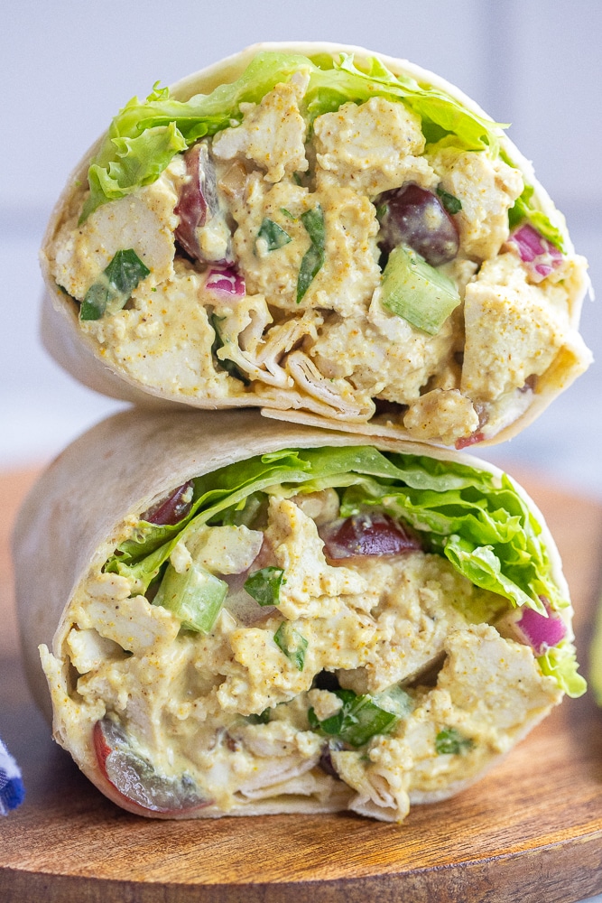 close up of a curried tofu wrap that has been cut in half and is stacked on top of eachother