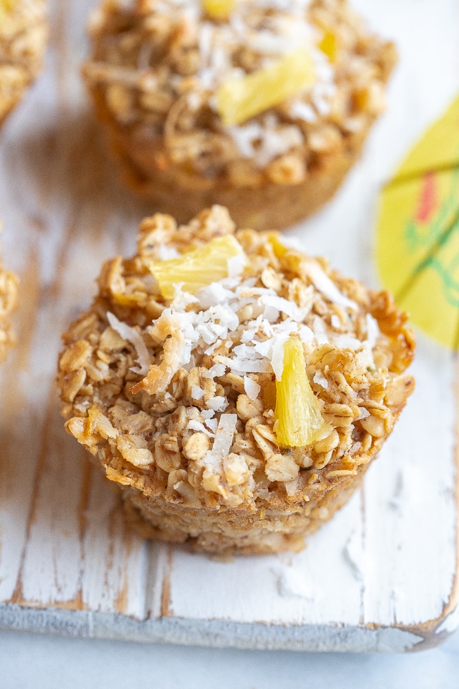 close up of a pina colada baked oatmeal cup topped with coconut and pineapple
