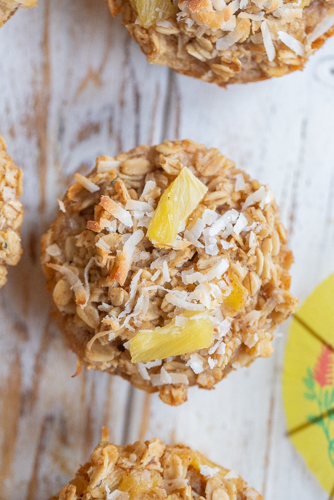 close up of a tropical baked oatmeal muffin on a cutting board