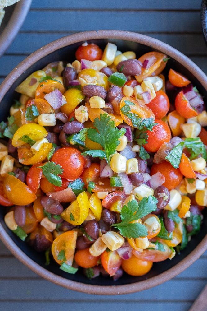 bowl of chunk cherry tomato salsa with beans and corn