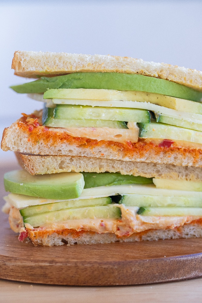 close up of a vegetarian hummus and avocado sandwich