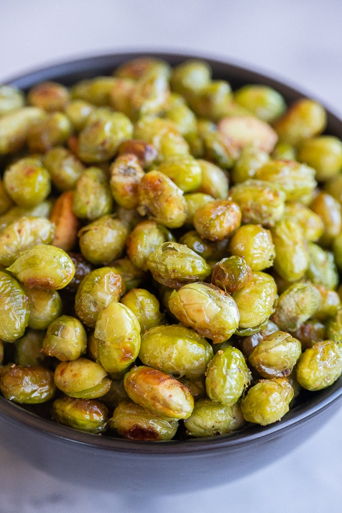 close up of a bowl of homemade crispy roasted edamame