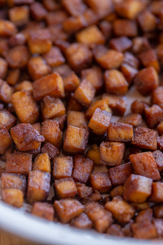 close up of crispy tofu pancetta in a frying pan