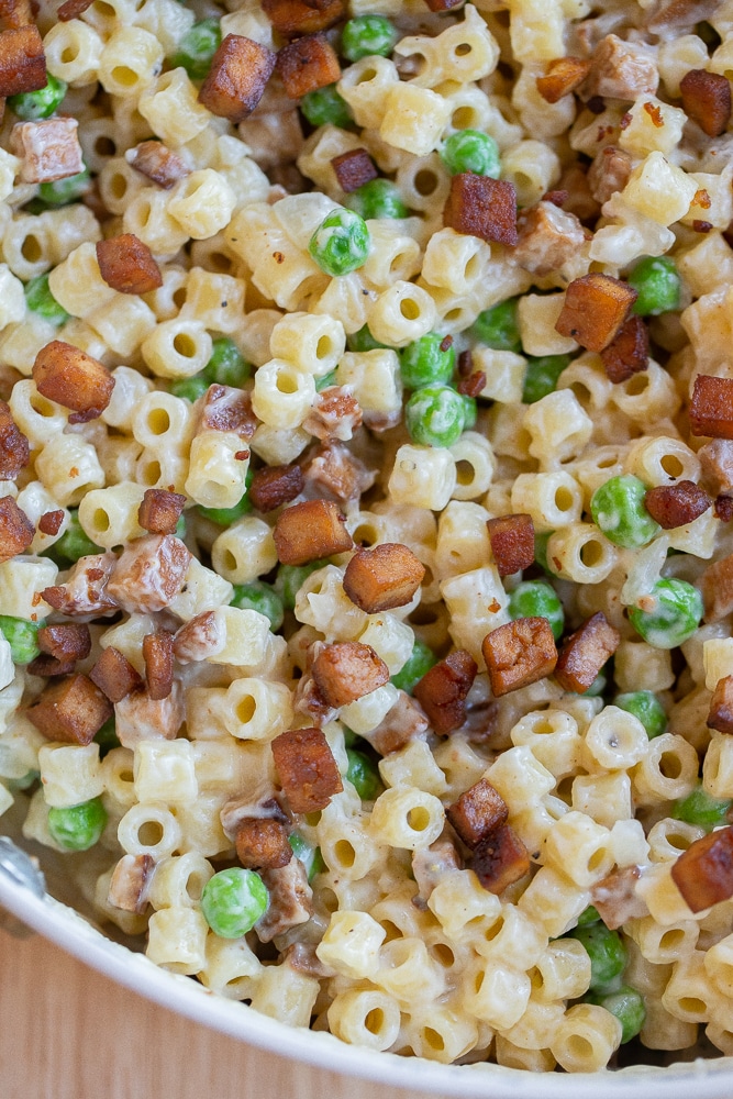 vegetarian pasta with peas and pancetta in a skillet