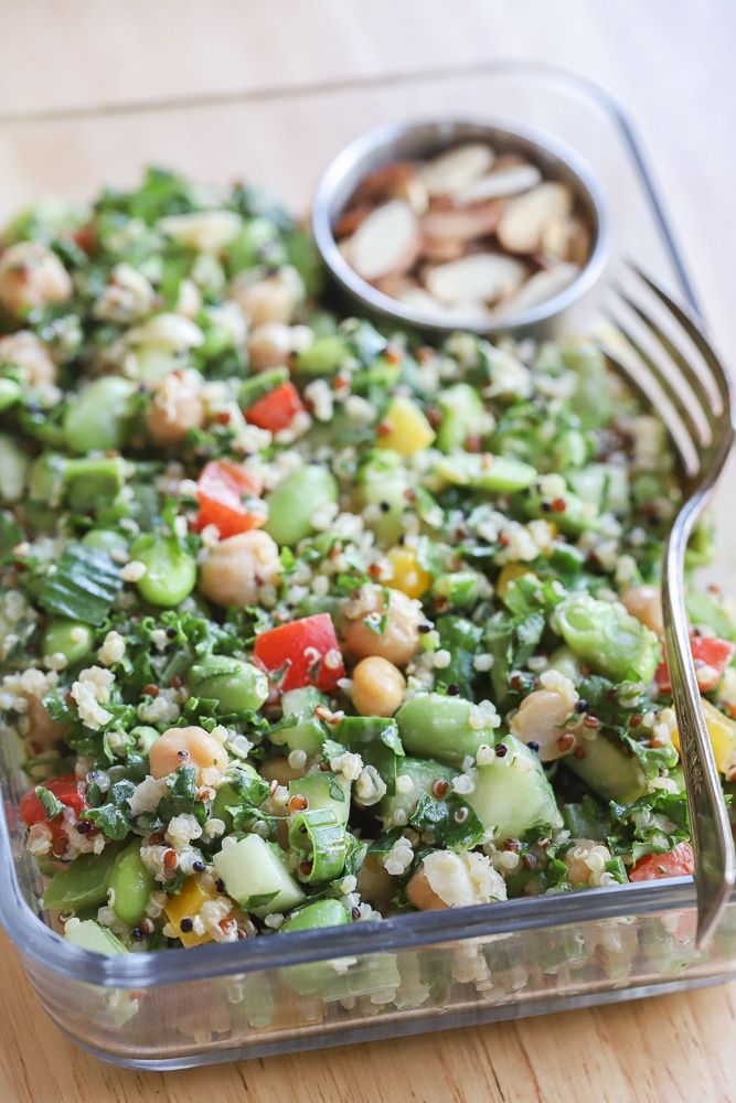 close up of the edamame chickpea salad in a meal prep container with a fork
