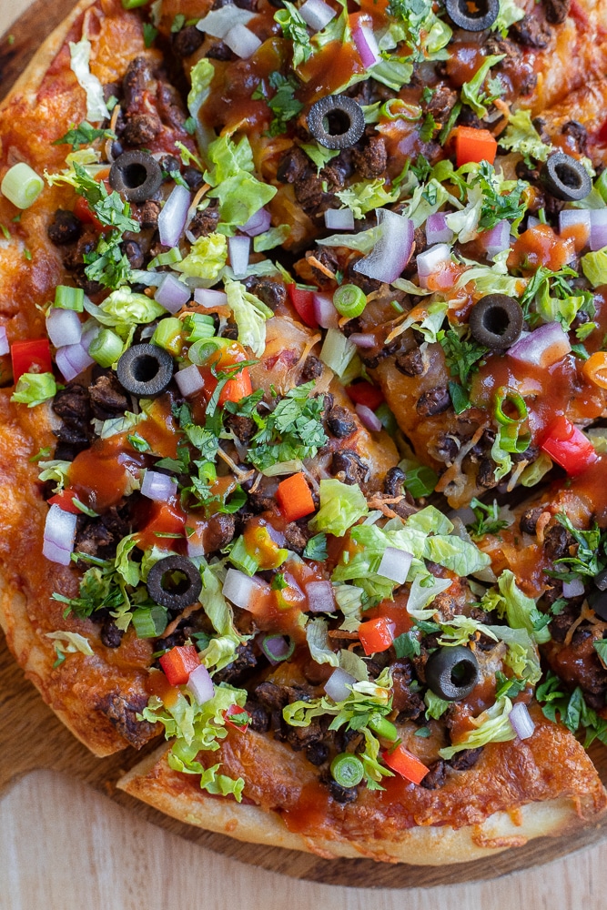 close up of taco pizza loaded with toppings