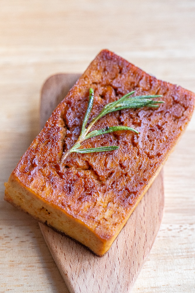 close up of a piece of vegetarian tofu steak with garlic and herbs