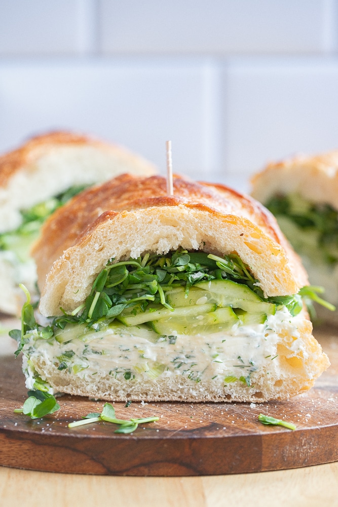 close up of a cream cheese cucumber sandwich cut in half