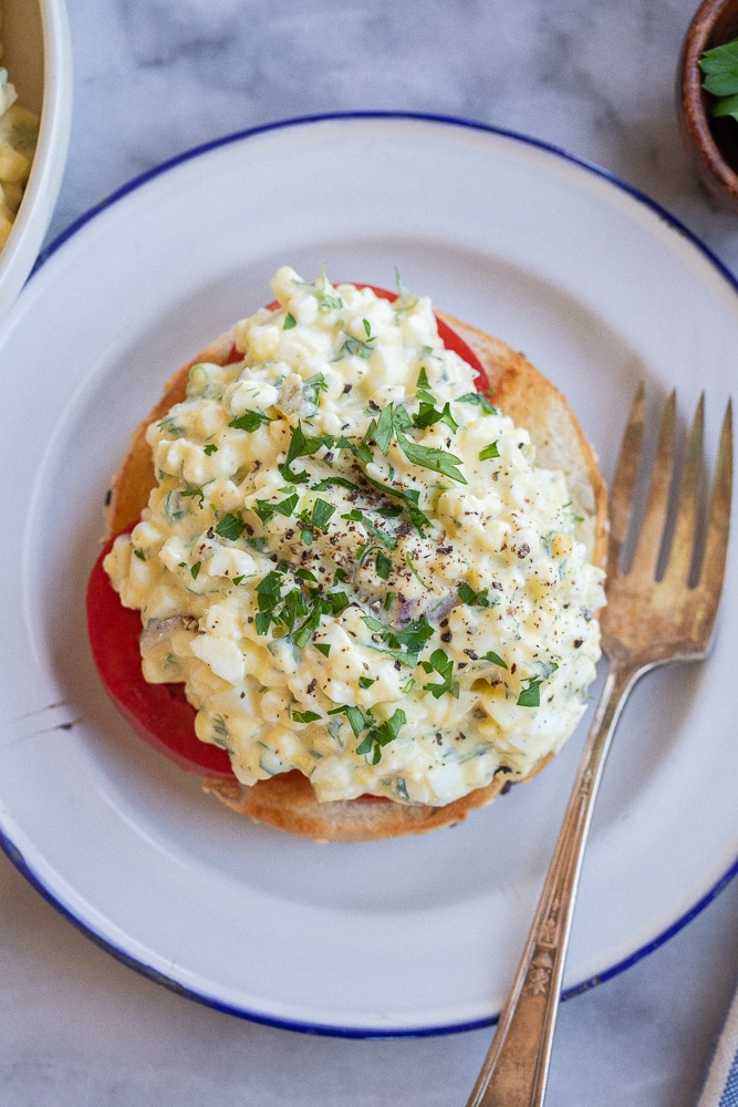 cottage cheese egg salad on a bagel with a fork