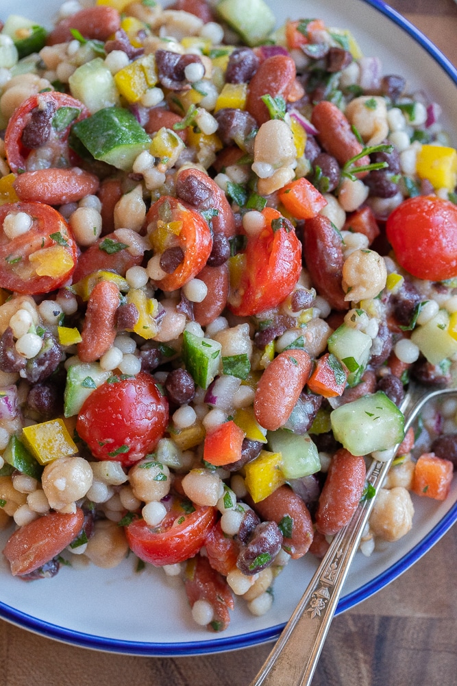 close up of a plate of four bean salad with veggies and couscous