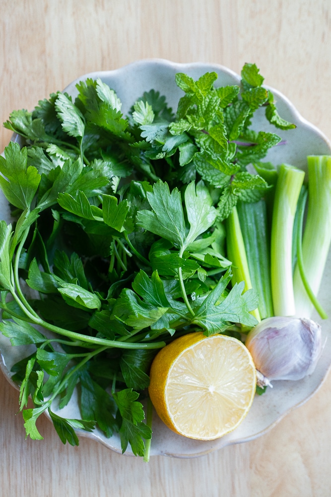 showing all the herbs needed to make this herbed yogurt dressing