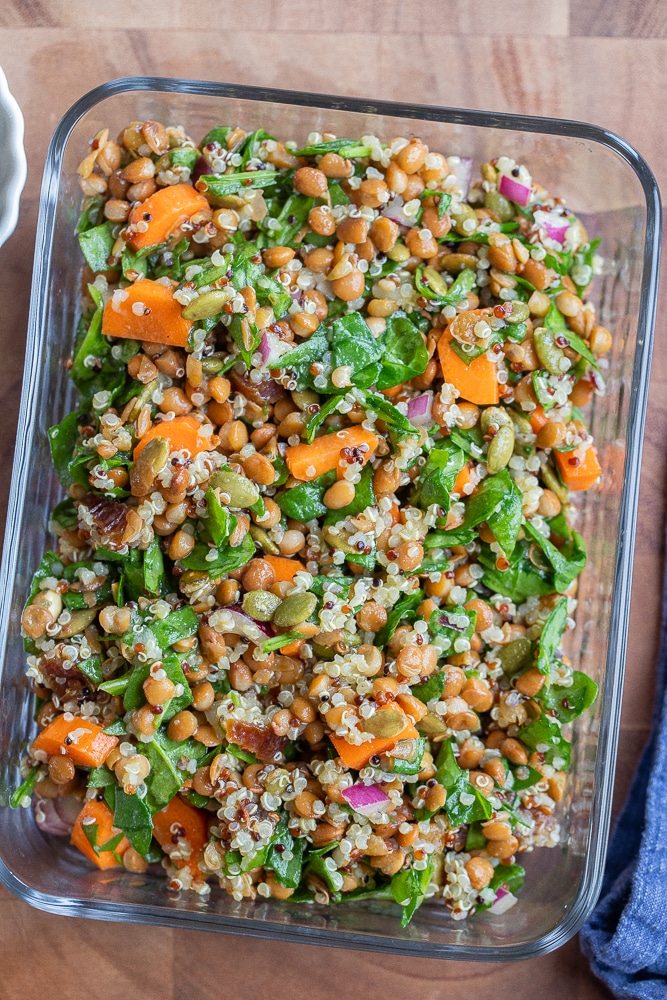 spinach lentil salad in a glass meal prep container