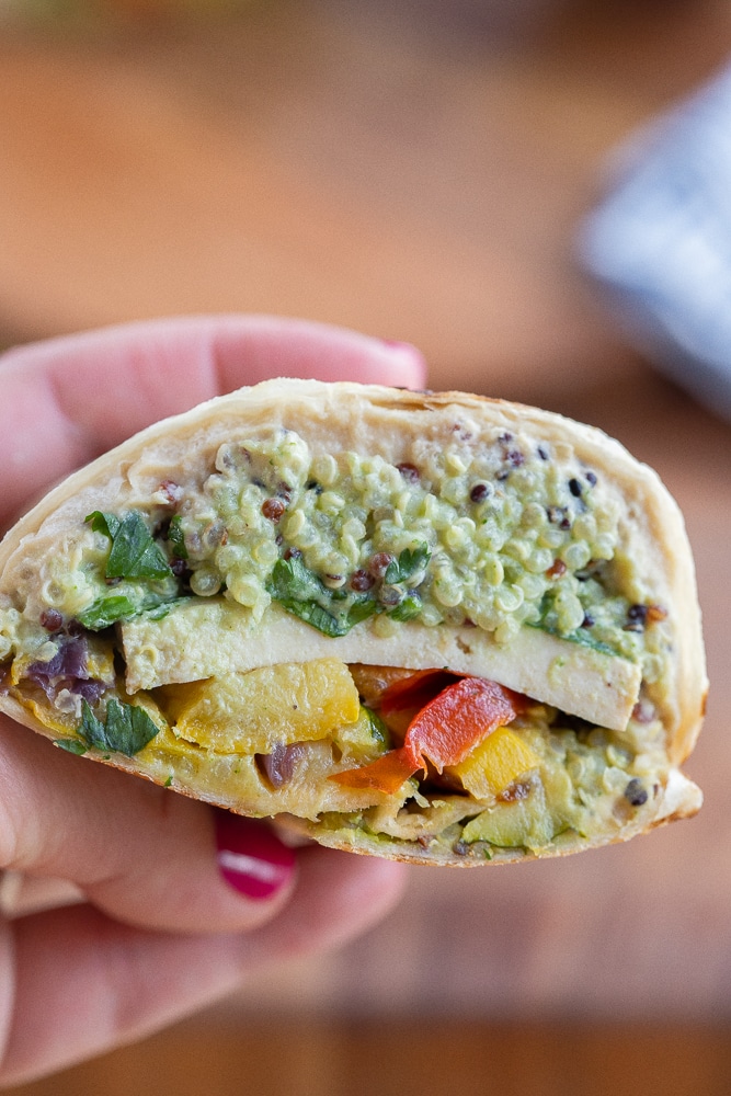 hand holding a cross section view of a high protein vegetarian wrap